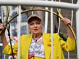 Vivienne Westwood suspends herself 10ft in the air inside a giant bird cage outside the Old Bailey