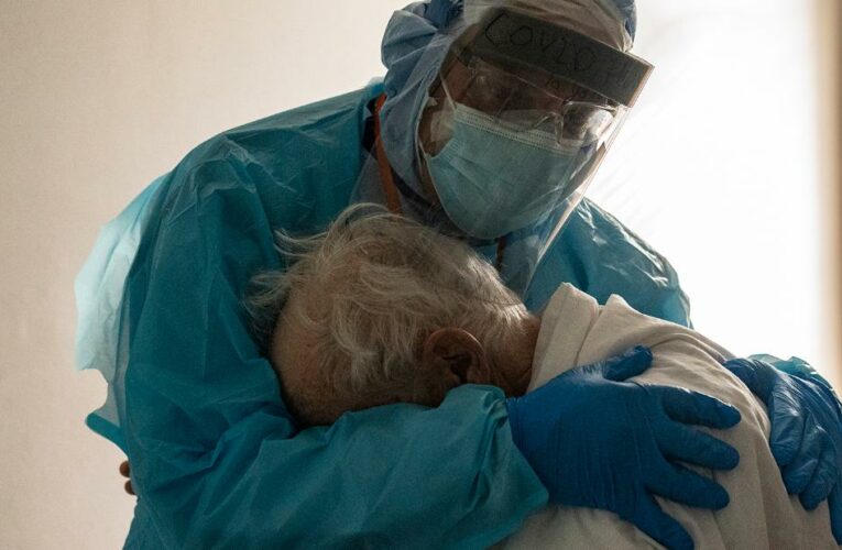 Doctor comforts elderly patient in heartbreaking photo