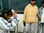 Chinese pupils are forced to smash their mobile phones after bringing them into the school 