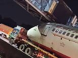 Moment a passenger plane gets STUCK under an overpass as it is transported along highway in Delhi