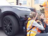 Moment mother drives into Insulate Britain activists with her 4×4 and pushes them along the road