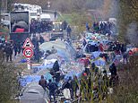 Armed French cops smash up squalid Dunkirk camp along disused rail tracks