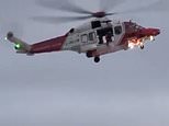 Coastguard helicopter airlifts mother and child to safety after woman fell at Welsh beach [VIDEO]