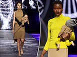 Bizarre runway show at Rome fashion week sees models strutting their stuff holding plastic DOLLS  