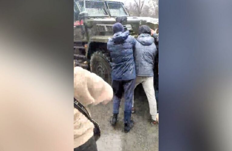 Watch: Ukrainian civilians stare down Russian military convoy