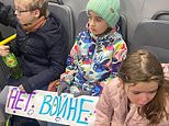 Terrified Russian mother tries to calm her little girl after women and children are arrested