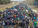 Civilians use lorries to block road to Europe’s biggest nuclear plant as Russian troops advance