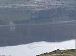 Couple claim their video of Loch Ness shows legendary monster swimming beneath the waters 