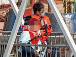 Children clutching teddies are brought ashore at Dover as more than 100 migrants cross the Channel